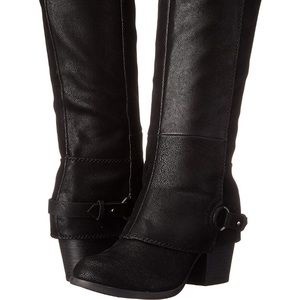 Tall black zip up heeled boots.